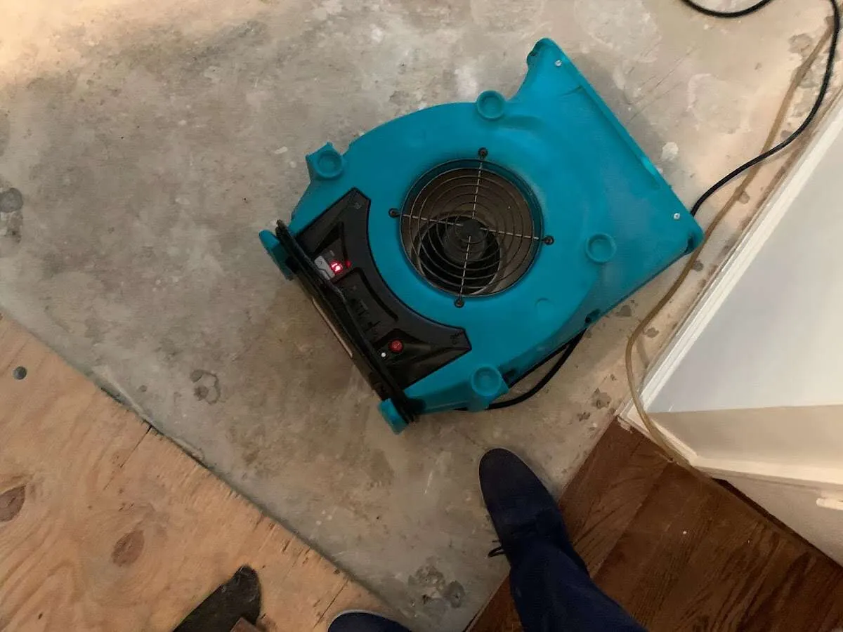 Air mover drying subfloor during Commercial Water Damage Restoration in Modesto